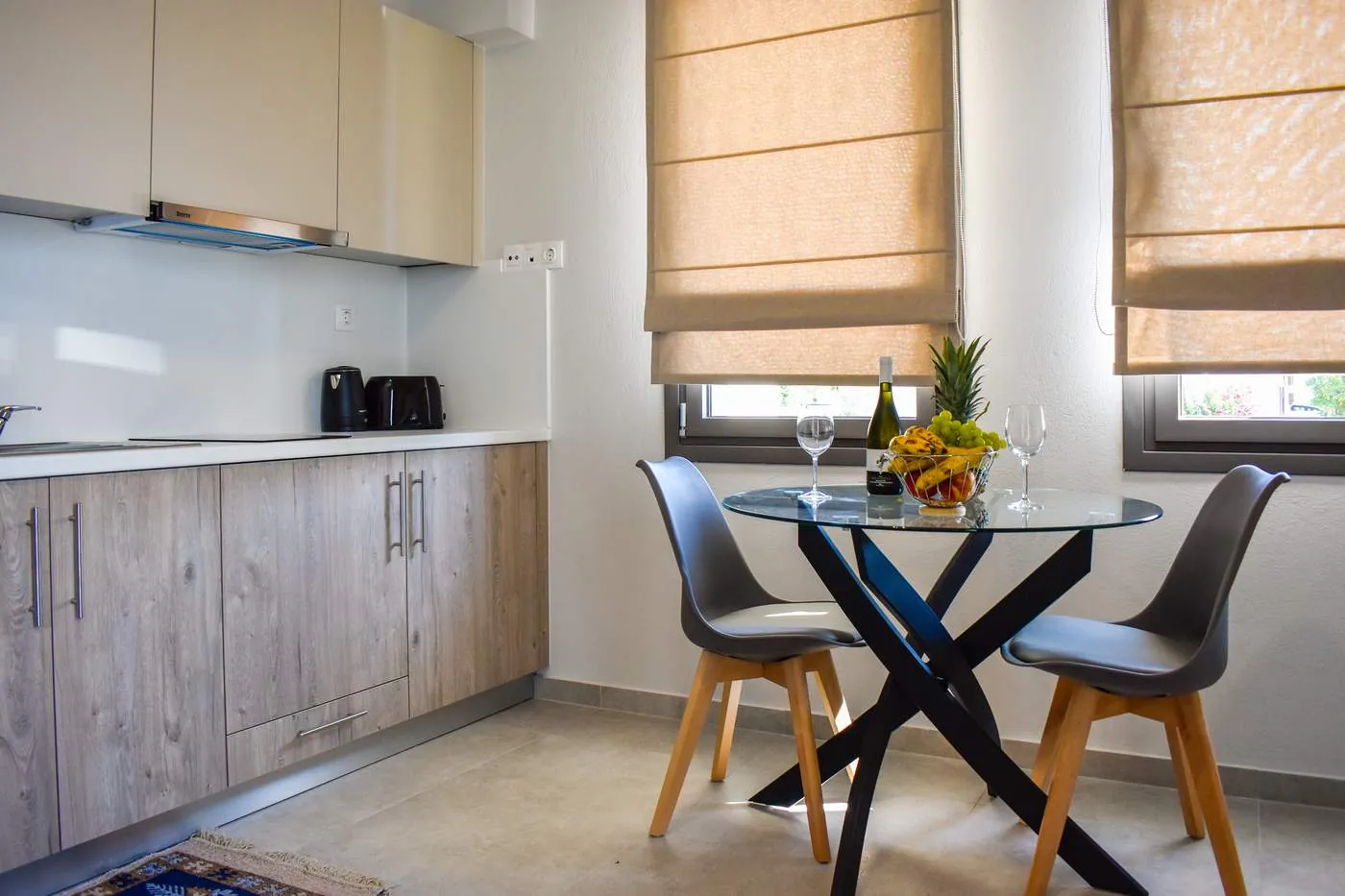 Kitchen with oak-finish cabinets and a round glass dining table
