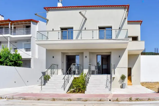 Shadow of Athos from the street: a two-storey white building with twin entrance stairs