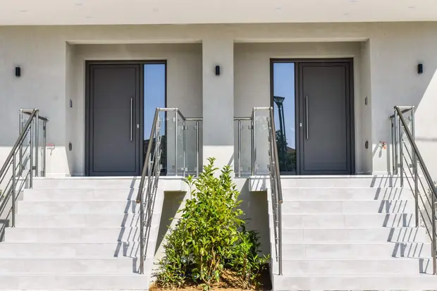 The two front doors at the top of their stairs