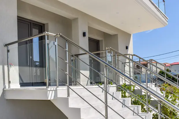 Entrance stairs with glass and steel railings