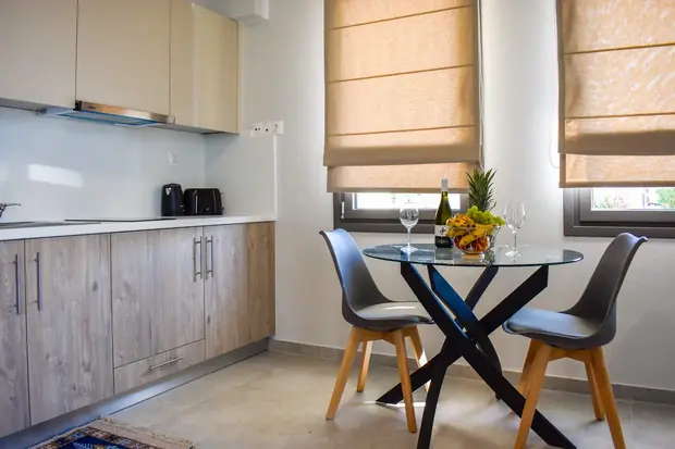 Kitchen with oak-finish cabinets and a round glass dining table
