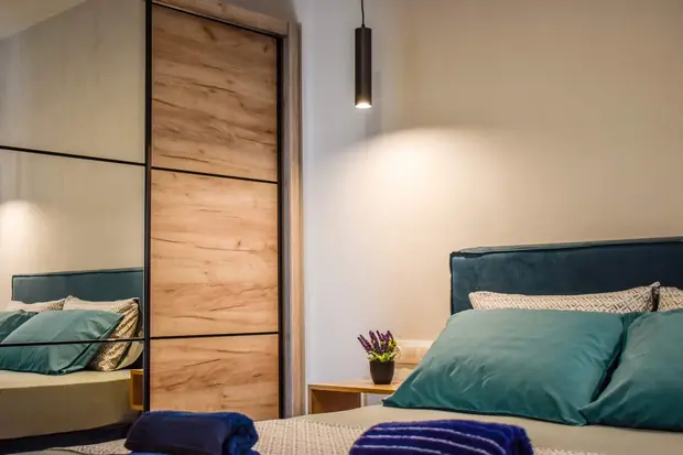 The double bed beside the two-door oak wardrobe